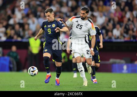 Munich Football Arena, Munich, Germany. 14th June, 2024. Euro 2024 Group A Football, Germany versus Scotland; Lawrence Shankland (SCO) holds off the challenge from Emre Can (GER) Credit: Action Plus Sports/Alamy Live News Stock Photo