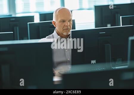 It technician works in a server room, maintaining and troubleshooting systems with expertise in cybersecurity and cloud computing Stock Photo