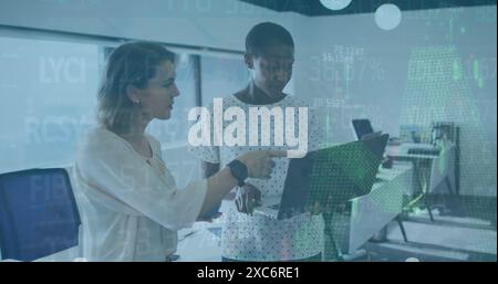 Image of financial data processing over two diverse female colleagues discussing at office Stock Photo