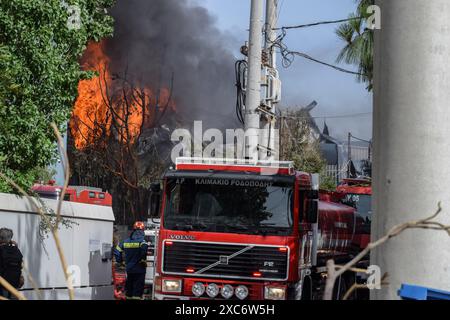 Athens, Greece. 12th June, 2024. Flames and black smoke rise into the sky while firefighters battle with a fire caused by multiple explosions at a cookware factory in the northern Athenian suburb of Kifissia. Authorities warned residents to stay inside due to a possible toxic cloud. (Photo by Dimitris Aspiotis/Pacific Press) Credit: Pacific Press Media Production Corp./Alamy Live News Stock Photo