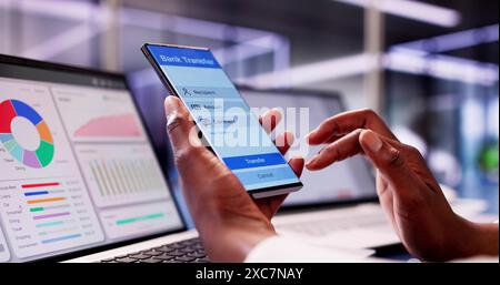 Smart Businesswoman Managing Her Budget and Paying Bills While Using an Online Banking App on Her Mobile Phone. Stock Photo