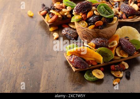 Dried tropical fruits with various nuts and raisins on a old wooden table. Stock Photo