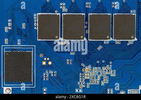 Close-up of Blue Circuit Board Components Stock Photo
