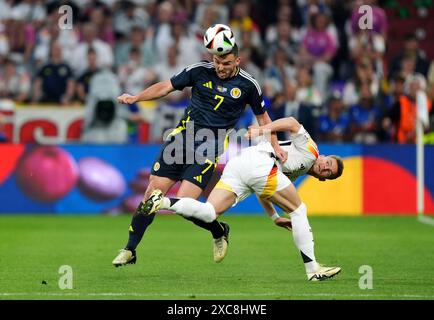 Scotland's John McGinn (left) and Germany's Maximilian Mittelstadt battle for the ball during the UEFA Euro 2024 Group A match at the Munich Football Arena in Munich, Germany. Picture date: Friday June 14, 2024. Stock Photo