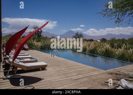 San Pedro de Atacama, Chile - Nov 29, 2023: Views of Licancabur Volcano from the pool at the luxury Tierra Atacama hotel Stock Photo