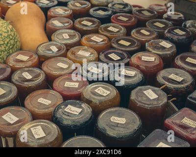 Glass jars with various types of natural delicious jam for cheese on a market stand Stock Photo