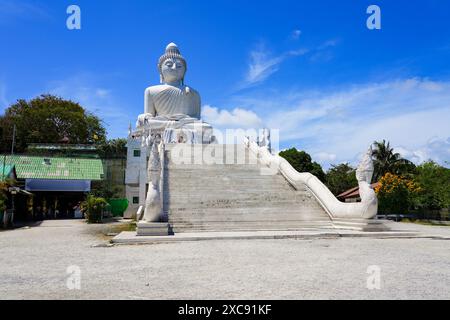 Stairs protected by Naga dragons leading up to the Great Buddha of Phuket aka Ming Mongkol Buddha, a seated Maravijaya Buddha statue covered in white Stock Photo