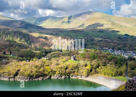 High view to Dolbadarn Castle by Llyn Peris with Moel Elio beyond in Snowdonia National Park from Dinorwic slate quarry.  Dinorwig Llanberis Wales UK Stock Photo