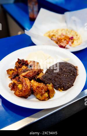 Fried plantains with beans and cream at Sarita's Pupuseria, Grand Central Market food court, Downtown Los Angeles, California, USA Stock Photo