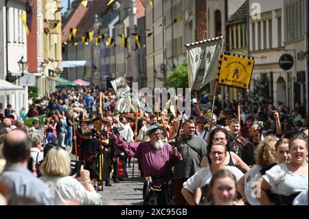 Lutherstadt Wittenberg, Germany. 15th June, 2024. The procession for Luther's wedding winds its way through the city center. The Wittenberg festival 'Luther's Wedding' takes place this weekend. On June 13, 1525, the former monk Martin Luther and the escaped nun Katharina von Bora married in Wittenberg. Credit: Heiko Rebsch/dpa/Alamy Live News Stock Photo