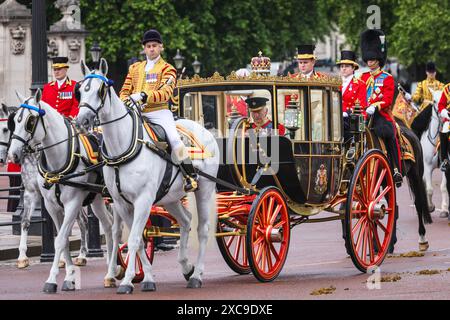 London, UK. 15th June, 2024. King Charles and Queen Camilla in their carriage, just as the rain starts. The annual Trooping the Colour ceremonial procession for the King's Birthday makes its way from Buckingham Palace to Horse Guards Parade for proceedings there, and back to the Palace for a balcony appearance. Credit: Imageplotter/Alamy Live News Stock Photo