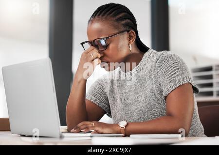 Headache, laptop and black woman in office, exhausted with 404 error, eye strain or web glitch. Frustrated, fatigue and tired girl with stress Stock Photo
