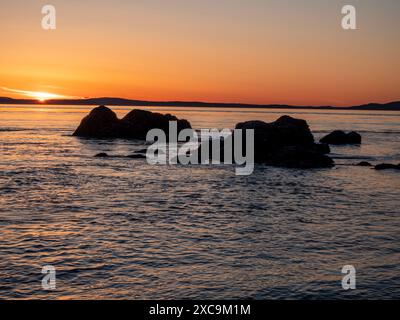 WA25342-00...WASHINGTON - The setting sun viewed from West Point In Deception Pass State Park. Stock Photo