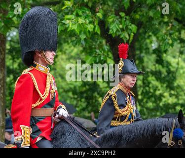 London, UK 15th Jun 2024.  The Duke of Edinburgh and Princess Royal return to Buckingham Palace on horseback through heavy rain, following the Trooping the Colour ceremony. Trooping the Colour takes place each year to celebrate the monarch's official birthday. This year it was the turn of the Irish Guards to troop their colour. The procession, to and from Horse Guards Parade passes along the Mall. Credit: MartinJPalmer/Alamy Live News Stock Photo