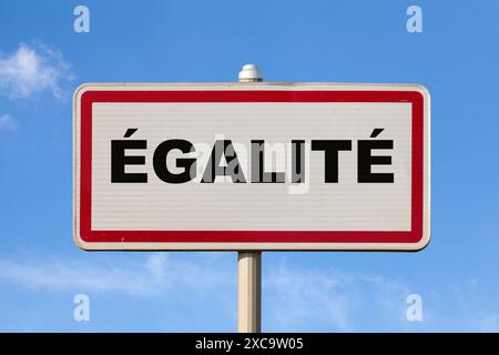 A French entry city sign against a blue sky with written in the middle in French 'Égalité', meaning in English 'Equality'. Stock Photo