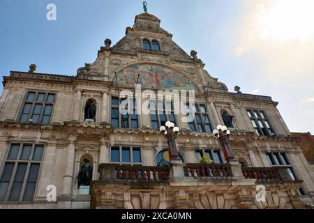 Old classical building with statues and blue sky in the City Center of Ghent. City with intense cultural life and gothic buildings in Belgium Stock Photo