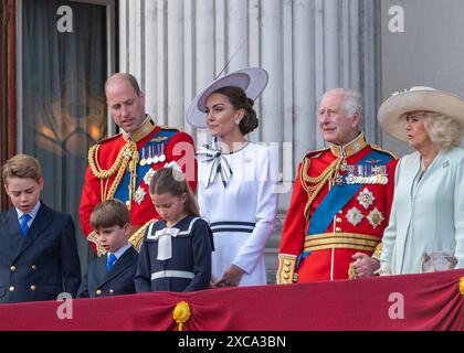 London, UK 15th Jun 2024.  The royal family make an appearance on the balcony of Buckingham Palace following the Trooping of the Colour ceremony.  They greet the crowds and watch the flypast. Left to right: Prince George, Prince Louis, HRH the Prince of Wales, Princess Charlotte, HRH the Princess of Wales, HM King Charles, HM Queen Camilla Stock Photo