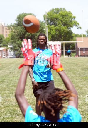 St. Louis, United States. 15th June, 2024. Detroit Lions wide receiver Jameson Williams, plays catch with a participant at the Jameson Williams 'Skills and Drills Football Camp,' at the Herbert Hoover Boys and Girls Club in St. Louis on Saturday, June 15, 2024. Photo by Bill Greenblatt/UPI Credit: UPI/Alamy Live News Stock Photo