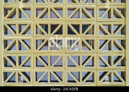 Decorative concrete block divider wall with a repeating geometric pattern Stock Photo