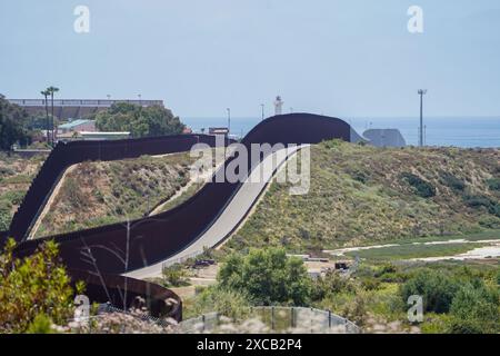 San Diego, United States. 15th June, 2024. The border wall separating Mexico and the United States are seen in San Diego. The border wall, the tortilla wall, is constructed along the United States-Mexico border to prevent migrants from crossing. Despite its presence, thousands of migrants still manage to climb over the wall and enter the United States illegally each year. Credit: SOPA Images Limited/Alamy Live News Stock Photo