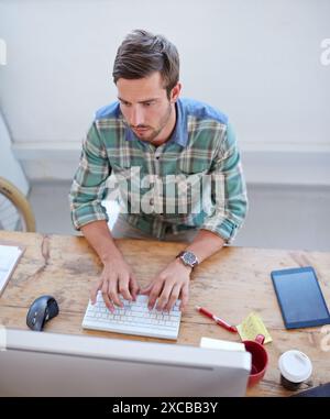 Startup, top view or man on computer for information technology, problem solving or online firewall. Technician, cybersecurity upgrade or web Stock Photo