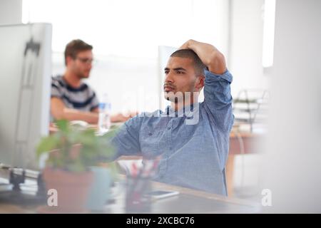 Doubt, thinking or man on computer in startup for information technology, problem solving or online firewall. Creative technician, programming or Stock Photo