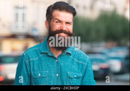 Smilling man outdoor. Male city portrait. Walking on town streets. Hipster outdoors. Stock Photo