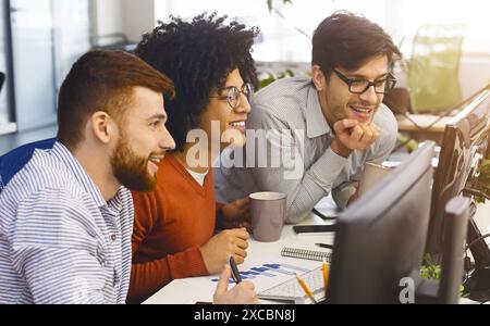 Diverse Group of Young Professionals Engaged in Collaborative Work Stock Photo