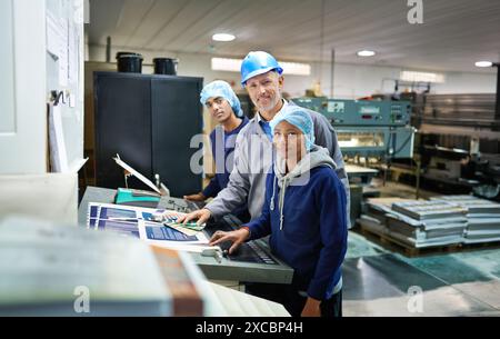 Group, people and portrait in factory for printing by machine, color chart and production at job. Employees, woman and man in helmet at industrial Stock Photo