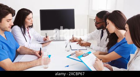 Doctor And Interns Having Online Lecture In Meeting Room Stock Photo