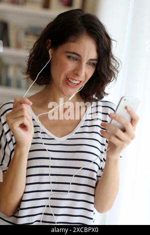 Woman listening music with Smartphone Stock Photo