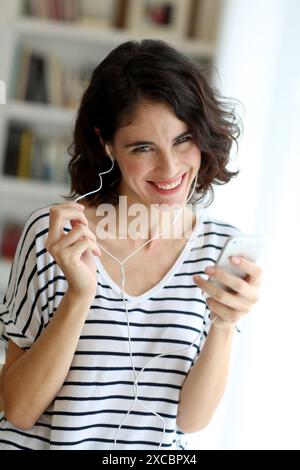 Woman listening music with Smartphone Stock Photo