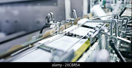 Industry, machine and paper in printing press for distribution or production for magazine, newspaper or publishing. Automation, printer and wholesale Stock Photo