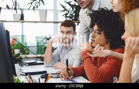 Diverse Team of Professionals Engaged in Collaborative Project Discussion Stock Photo