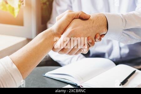 Handshake of two businessmen during lunch break Stock Photo