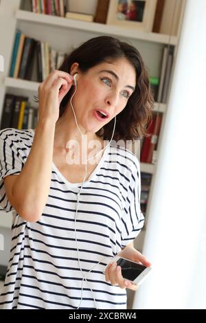 Woman listening music with Smartphone Stock Photo