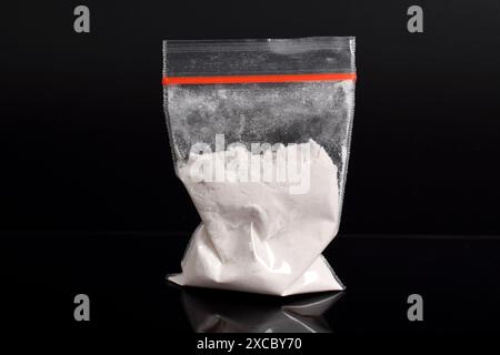 Cocaine in plastic packet isolated on black background. illustration of illegal drug substances, narcotics Stock Photo