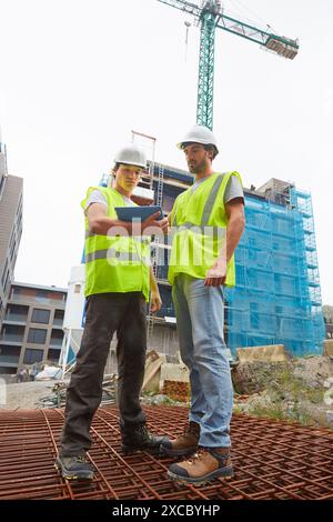 Workers consulting a tablet. Homebuilding. Construction work. Donostia. San Sebastian. Gipuzkoa. Basque Country. Spain Stock Photo