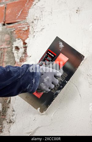 Rendering a brick wall using trowel, new homes under construction, construction site Stock Photo