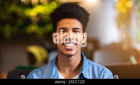 Young Black Guy Smiling in Denim Shirt Stock Photo