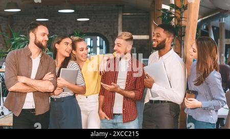 Successful workers having break, talking and laughing Stock Photo