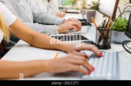 Cropped of Professionals Working on Laptops at Bright Modern Office Stock Photo