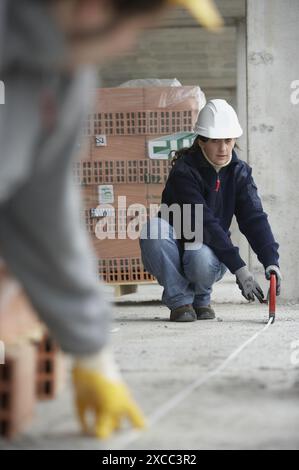 Workers measuring with measuring tape. Housing construction, apartments. San Sebastian, Gipuzkoa, Euskadi. Spain. Stock Photo