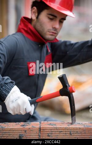 Worker with pickaxe, building construction. Stock Photo
