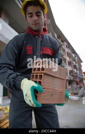 Worker with bricks. Building construction. Stock Photo