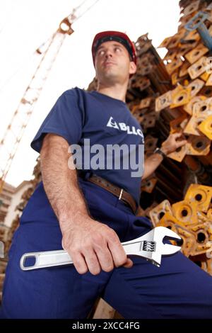 Worker holding adjustable spanner in a construction site Stock Photo