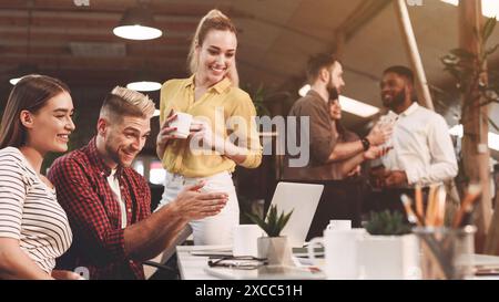 Colleagues working on project, using laptop at workplace Stock Photo