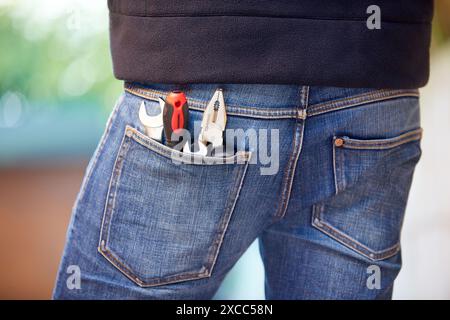 Tools in jeans pocket. DIY. Stock Photo