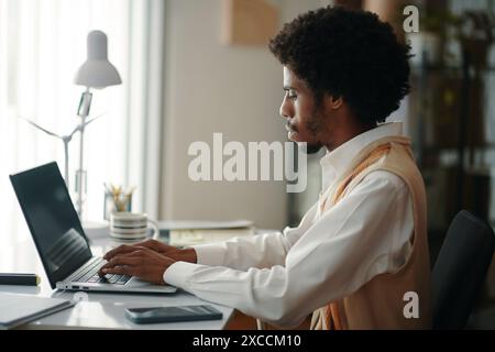 Businessman working on laptop in company office Stock Photo