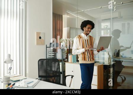 Developer working on laptop in company office Stock Photo